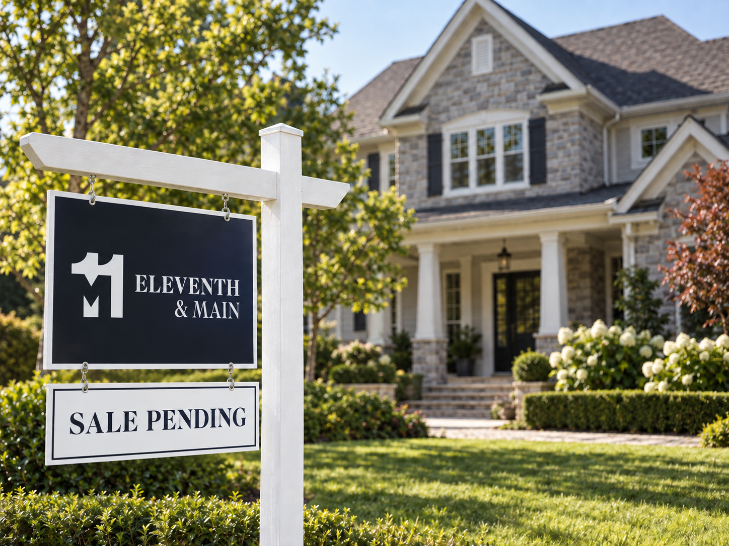 Home for sale with Eleventh and Main branding beneath the real estate sign